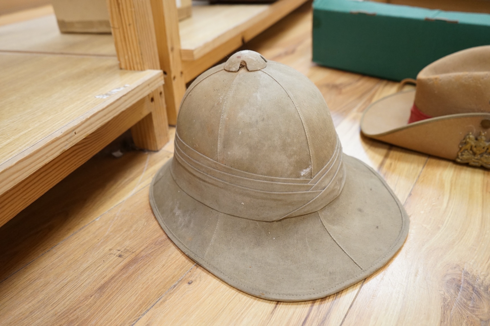 A collection of military related items, including an instrument panel from a WWII RAF Lancaster bomber aircraft, a Bosun’s whistle, a Heckler and Koch ‘bullet’ pen, a WWII tin hat (possibly police), a pith helmet, an Aus